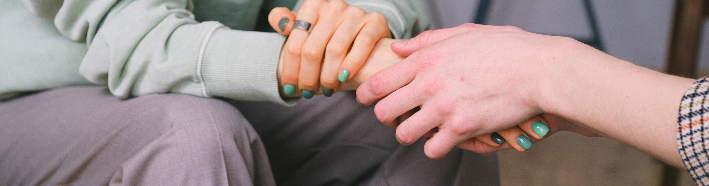 A close up of two people holding hands