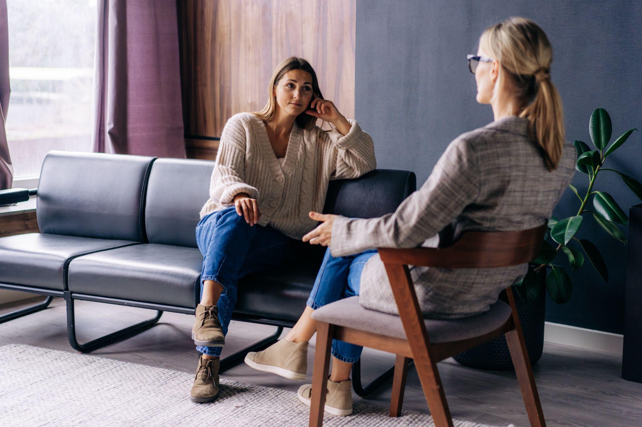 A young woman in a consultation with a professional psychologist listens to advice on improving behavior in life.